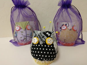 Cute little owl pin cushions adorned with decorative buttons. A cute addition to any sewing room.