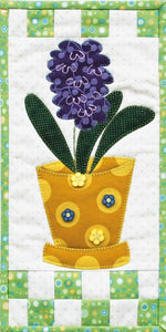 This pattern features a hyacinth flower in a gardening pot. Details such as the leaves and flower buttons give this applique project a finished look.