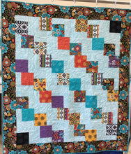 Load image into Gallery viewer, Beautiful handmade quilt using a 5&quot; charm pack that contains beautiful turquoise, purple and browns colors. 
