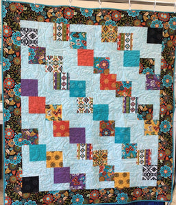 Beautiful handmade quilt using a 5" charm pack that contains beautiful turquoise, purple and browns colors. 
